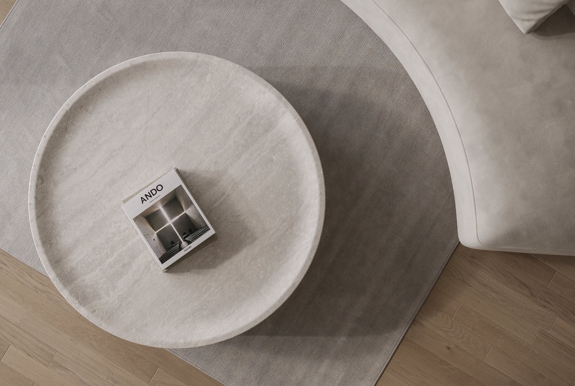 洞石圓几正俯視與 ANDO 書籍的材質細節